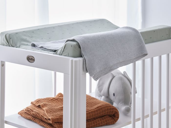 Close up photo of modern nursery containing Banskia 2PCE Hardwood Baby Cot with Storage and Changing Table Set in White
