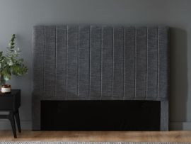 Close up photo of modern bedroom containing cannes queen upholstered headboard in charcoal fabric