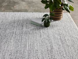Close up of Elora Grey Cotton Area Rug in a modern living room