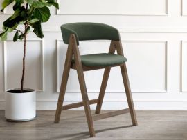 photo of modern dining room featuring gaudi hardwood counter stool in walnut finish and green fabric