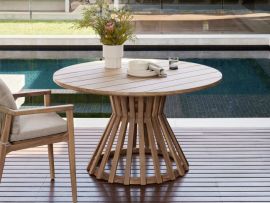 Modern outdoor alfresco space containing Stavanger Round Acacia Outdoor Dining Table