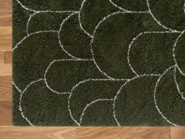 Close up photo of Turret Pattern Area Rug in Green in a modern living room