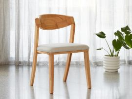 photo of modern Villa Dining Chair in Natural Sustainable Hardwood | Beige Fabric in a modern dining room