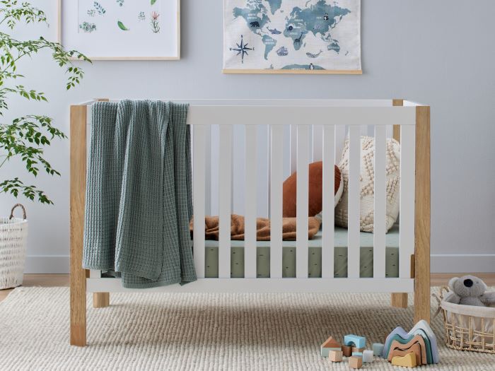 Photo of modern nursery with Aster Hardwood Convertible Baby Cot in White and Natural