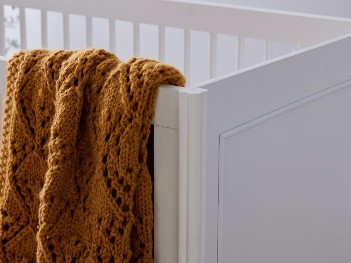 Close up photo of modern nursery containing Banskia 2PCE Hardwood Baby Cot with Storage and Changing Table Set in White