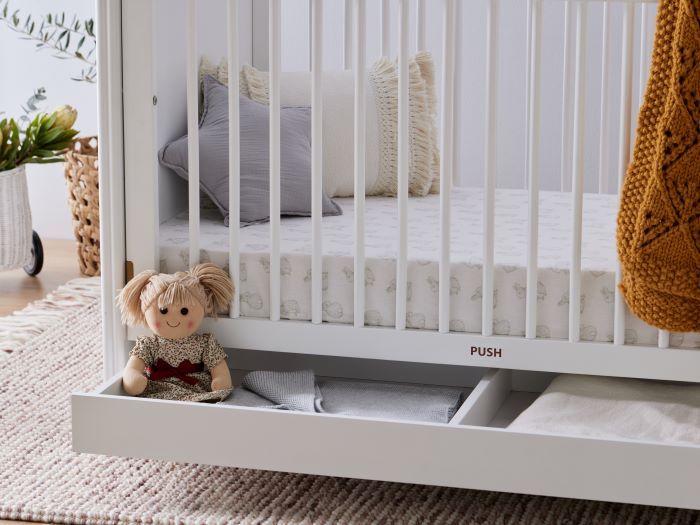 Close up photo of modern nursery containing Banskia 2PCE Hardwood Baby Cot with Storage and Changing Table Set in White