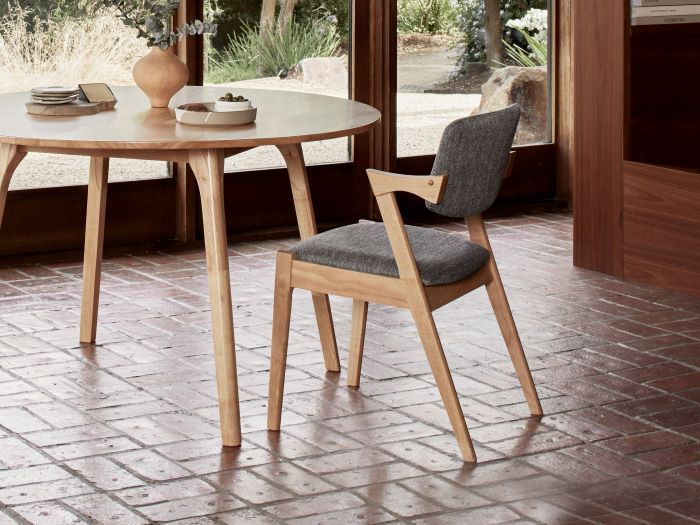 close up photo of Bella hardwood dining chair natural with black fabric in modern dining room