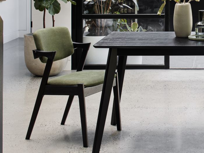 Side view photo of Bella black hardwood dining chair with green fabric