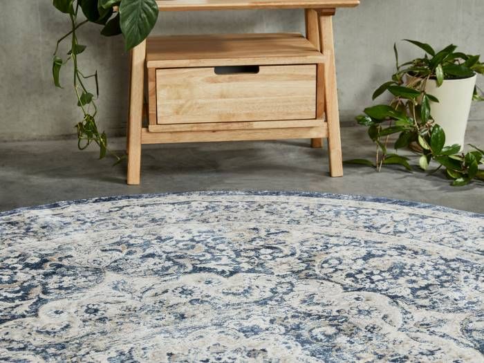 Close up photo of Cali Round Traditional Pattern Rug with modern Rome Bedside Table