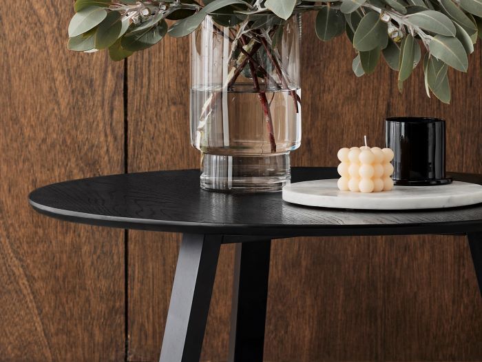 Close up photo of modern living room containing Cannes 2PCE Round Hardwood Coffee and Side Table Set in black  