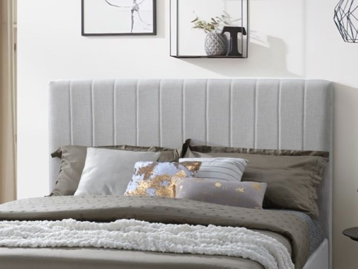 Modern bedroom containing Cannes queen upholstered headboard in beige
