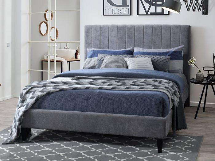 Modern bedroom containing Cannes queen upholstered headboard in grey