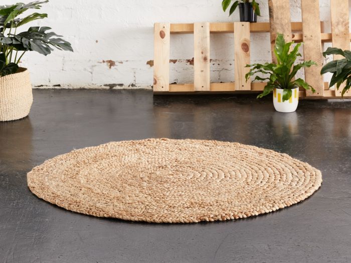 photo of round eden jute rug on floor with plants