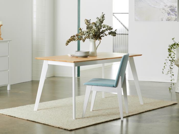 Side view of Modern dining room containing Finn hardwood dining table in natural with Finnn hardwood dining chair in aqua
