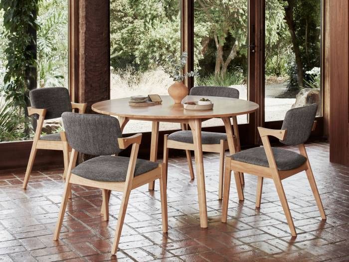 photo of modern dining room with Bella hardwood dining chairs with black fabric and Franki round hardwood dining table in 5pce dining set
