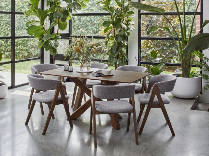 Photo of modern dining room containing Gaudi Hardwood Dining Table in Walnut with Gaudi Dining Chair in walnut and grey