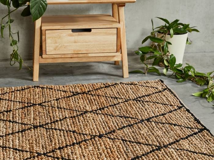 Close up photo of Kenya Diamond Pattern Jute Area Rug in Natural and Black with modern Rome Bedside Table
