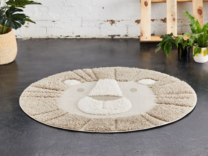 photo of leo lion round kids rug in beige on floor with palettes and plants