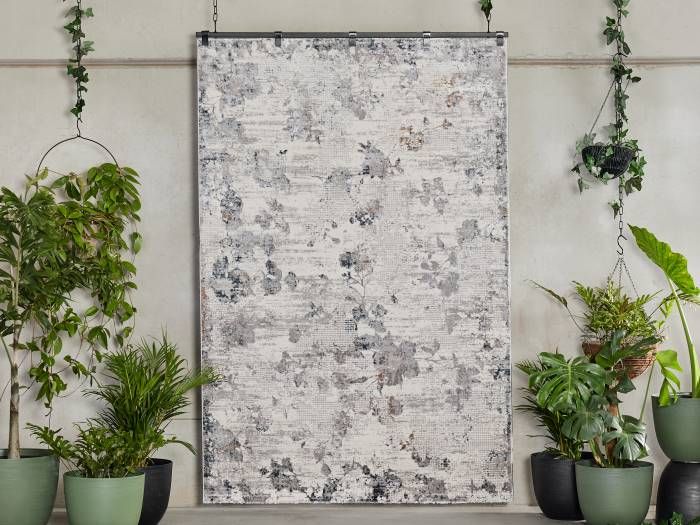 Photo of Orissa Vintage Floral Pattern Area Rug handing from rod