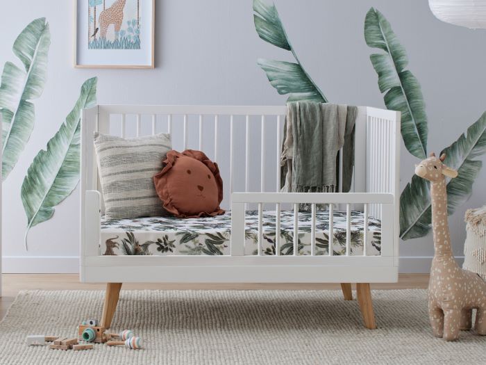 Close up photo of modern nursery containing Rio 3 PCE Hardwood Cot and Change Table Set in white and natural