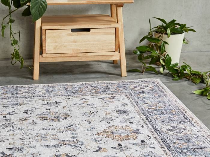 Close up photo of Wren Traditional Floral Pattern Rug with modern Rome Bedside Table